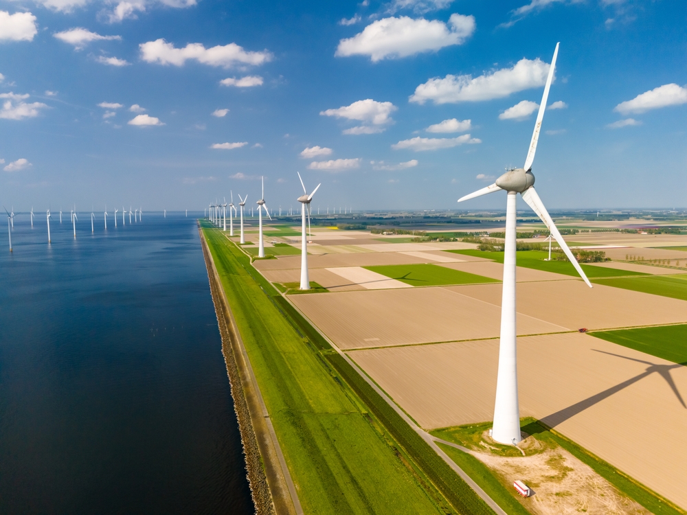 Wind Turbines in a field alongside other wind turbines which are in the sea | GWO Sea Survival Training course