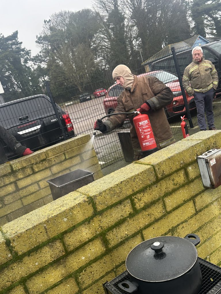 Finn is using a fire extinguisher as part of his Fire Prevention and Fire Fighting course which makes up the 4-Part STCW Basic Safety Training Week